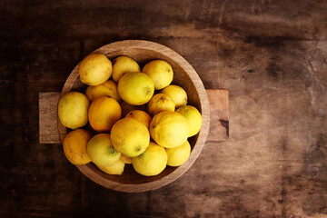Image of group of fresh lemons over old vintage wooden table