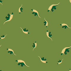 Beige colored dinosaurs random ornament seamless pattern. Green background. Wildlife nature backdrop.