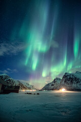 Aurora borealis, Northern lights with stars glowing on snowy mountain in the night sky on winter at...