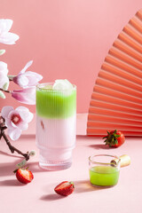 Strawberry matcha latte in a glass cup.