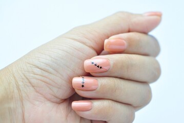 woman hand painted nude nails with gel nail polish