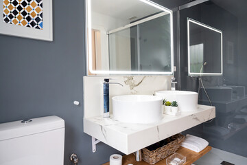 Interior of light modern bathroom with a mirror with light