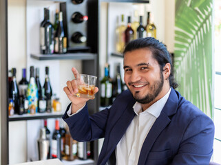 Hispanic businessman drinking mixed drink