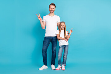Full size portrait of handsome guy cute girl standing fingers show v-sign isolated on blue color background