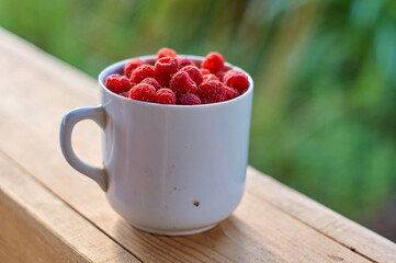 cup of the raspberry on the wooden table