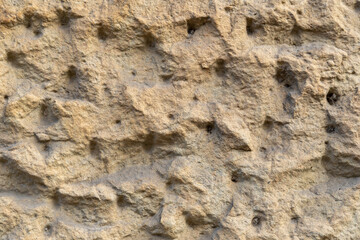 Naklejka premium Rough wall plaster background texture. Dirty building exterior pattern of a surface. Stucco material structure on a facade.