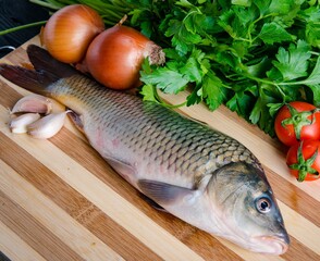 Uncooked fish on cutting board in meal preparation concept