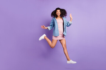 Full length body size photo woman jumping running in short dress laughing happy isolated pastel purple color background