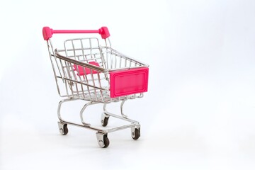 Mini shopping cart or trolley isolated on white background with copy space.