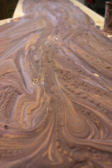 chocolate paste chilling on a table, Mexican artisan stone shaped chocolate, made in mexico, brown background