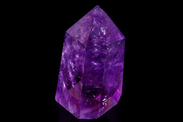 Macro mineral stone Amethyst crystal on a black background