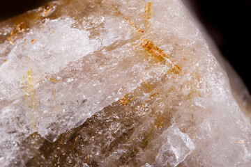 Macro mineral stone Rutile in quartz on black background