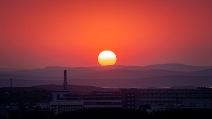 Sunset over the hills in clear weather gorizon clouds