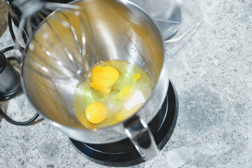Process of beating eggs in a mixer: making homemade dough for baking.