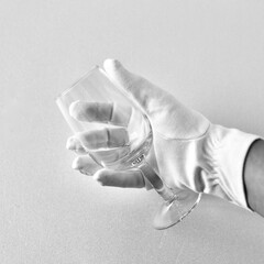 glass in hand, with white gloves, bartender