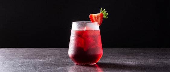 Strawberry cocktail in glass on black background. Panorama view
