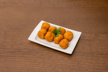 serving of round battered croquettes ready to serve as tapas in a Spanish tapas restaurant