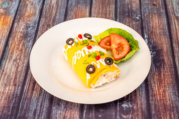 recipe of a typical causa limeña from Peru decorated on the top with black olives, mayonnaise, pepper and peas