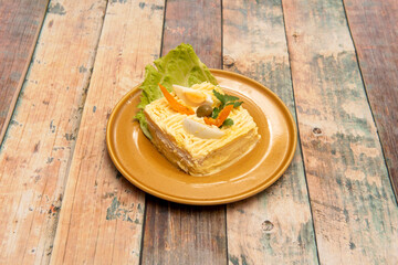 Homemade causa limeña plate with olives, tomato, coriander, boiled eggs, mayonnaise and lettuce