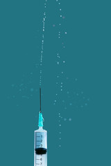 a syringe with vaccine on blue background