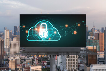 Padlock icon hologram on road billboard over panorama city view of Kuala Lumpur at sunset to protect business, Malaysia, Asia. The concept of information security shields.