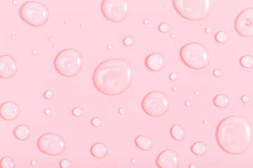 cosmetic liquid transparent gel with bubbles on pink background. Flat lay style.