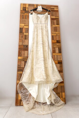 Wedding dress hanging against a mirror