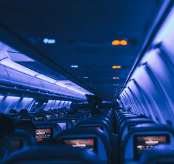 Gordijnen indoor flight airplane people travel new normal blue  © Alberto GV PHOTOGRAP