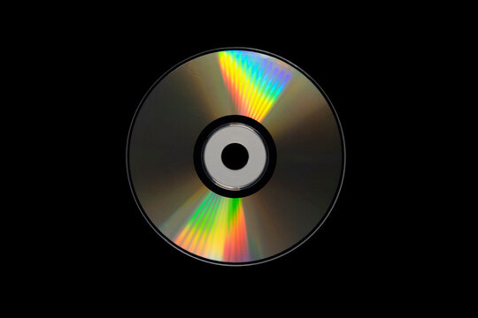cd or dvd, storage data information technology. music and movie record. holographic side of the compact disc. a compact disc isolated on black background.