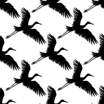 Vector seamless pattern of black hand drawn flying crane bird silhouette isolated on white background