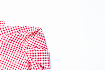 Top view tablecloth checkers picnic for the weekend. Fabric checkers cloth red and white square grid on a white background top view with copy space.