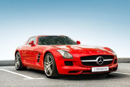 Kiev, Ukraine - May 19, 2020: Luxury supercar Mercedes-Benz SLS AMG against the sky. Wallpaper. For sale. For advertising. Red supercar