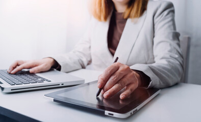 businesswoman hand using smart phone, tablet payments and holding credit card online shopping, omni channel, digital tablet docking keyboard computer at office in sun light