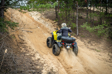 Professional quad biker rides fast on sand. Quad racing, ATV 4x4 © Antonio