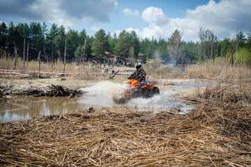 Atv rider in muddy water. Xtreme utv ride
