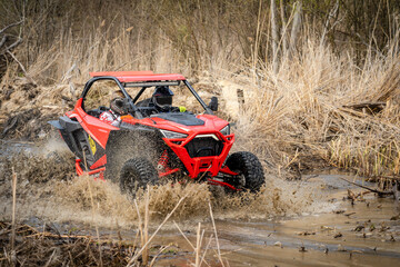 Cool view on hard ride UTV in muddy water © Antonio