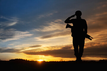 Silhouette of a soldiers against the sunrise. Concept - protection, patriotism, honor.