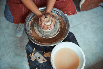 Female ceramist hands making pottery in workshop