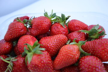 red ripe strawberry close-up on a white background