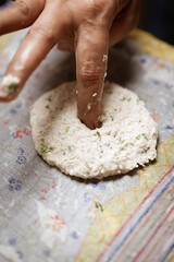 Close-up of Preparation of  dahi vada - mixture of grind urad dal with condiments and ingredients and roasted cumin and green fresh coriander for preparation of chaat.