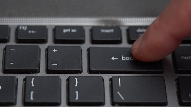 Backspace button pressing a lot of times on keyboard, laptop keyboard close up