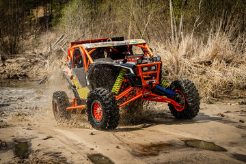 Fast ATV and UTV driving in mud and water. Quad racing, ATV 4x4.