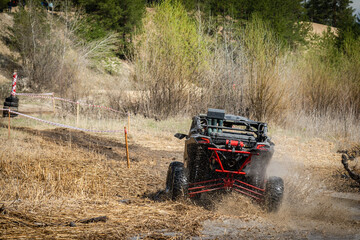 Offroad vehicle in the action and makes splashes of dirty water