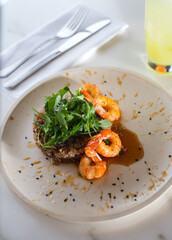 shrimp with vegetables dish with fruit juice glass