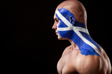 Scotland fan. Soccer or football athlete with flag bodyart on face. Sport concept with copyspace.