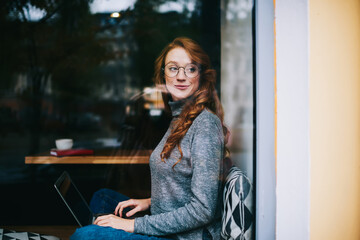 Smiling woman using laptop for work