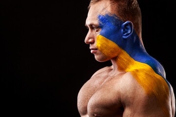 Ukraine fan. Soccer or football athlete with flag bodyart on face. Sport concept with copyspace.