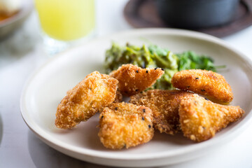 Chicken fingers in a dish placed in a table with other elements