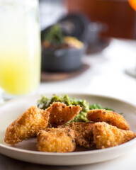 Chicken fingers in a dish placed in a table with other elements