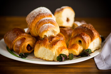 baked sweet homemade buns with plum inside